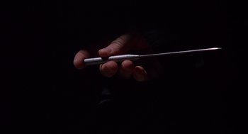 Movie still from “When a Stranger Calls” (1979), directed by Fred Walton – A person holding a metal object in their hand; Extreme Close Up shot, Low angle