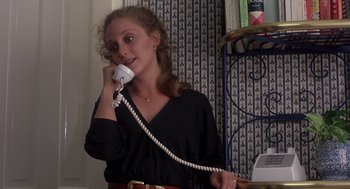 Movie still from “When a Stranger Calls” (1979), directed by Fred Walton – A woman holding a phone to her ear while standing in a room; Close Up shot, Low angle