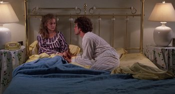 Movie still from “When a Stranger Calls” (1979), directed by Fred Walton – A man and a woman sitting on a bed talking to each other; Medium shot, High angle