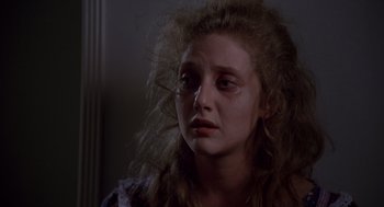 Movie still from “When a Stranger Calls” (1979), directed by Fred Walton – A young woman is crying in a dark room; Close Up shot, Over the shoulder angle