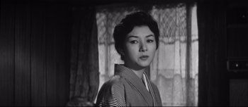 Movie still from “When a Woman Ascends the Stairs” (1960), directed by Mikio Naruse – An old photo of an asian woman in a kimono; Close Up shot, Low angle