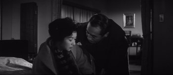 Movie still from “When a Woman Ascends the Stairs” (1960), directed by Mikio Naruse – A man and a woman are looking at each other; Close Up shot, Low angle