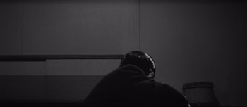 Movie still from “When a Woman Ascends the Stairs” (1960), directed by Mikio Naruse – A black and white photo of a person sleeping; Medium shot, Over the shoulder angle