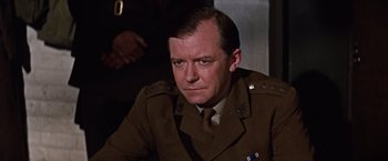 Movie still from “Where Eagles Dare” (1968), directed by Brian G. Hutton – A person wearing a military uniform; Close Up shot, Low angle