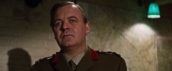 Movie still from “Where Eagles Dare” (1968), directed by Brian G. Hutton – A person wearing a military uniform; Close Up shot, Low angle