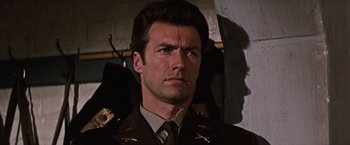 Movie still from “Where Eagles Dare” (1968), directed by Brian G. Hutton – A man in a military uniform is looking at the camera; Close Up shot, Low angle