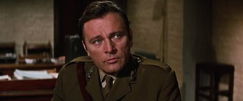 Movie still from “Where Eagles Dare” (1968), directed by Brian G. Hutton – A person wearing a uniform; Close Up shot, Low angle