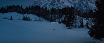 Movie still from “Where Eagles Dare” (1968), directed by Brian G. Hutton – A person is skiing down a snowy hill; Extreme Wide shot, High angle