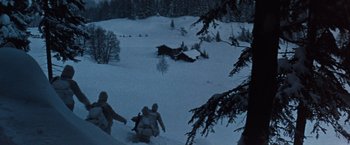 Movie still from “Where Eagles Dare” (1968), directed by Brian G. Hutton – A group of people riding down a snow covered slope; Extreme Wide shot, High angle