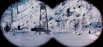 Movie still from “Where Eagles Dare” (1968), directed by Brian G. Hutton – A view of a fire lookout tower from a vehicle; Extreme Wide shot, High angle