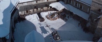 Movie still from “Where Eagles Dare” (1968), directed by Brian G. Hutton – An aerial view of people in the snow near a helicopter; Extreme Wide shot, High angle