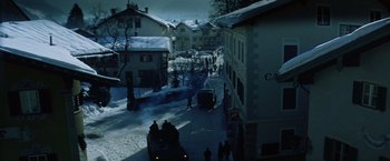 Movie still from “Where Eagles Dare” (1968), directed by Brian G. Hutton – People are walking down a snowy street in a city; Extreme Wide shot, High angle