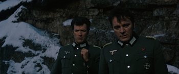 Movie still from “Where Eagles Dare” (1968), directed by Brian G. Hutton – A couple of men standing next to each other; Close Up shot, Low angle