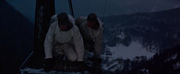 Movie still from “Where Eagles Dare” (1968), directed by Brian G. Hutton – A couple of men standing on top of a tree branch; Medium shot, Low angle
