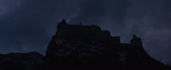 Movie still from “Where Eagles Dare” (1968), directed by Brian G. Hutton – A castle on top of a hill at night; Extreme Wide shot, Low angle