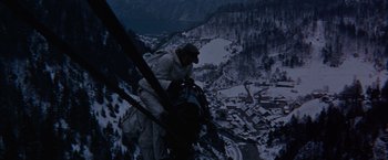 Movie still from “Where Eagles Dare” (1968), directed by Brian G. Hutton – A man standing on top of a building on top of a mountain; Wide shot, High angle