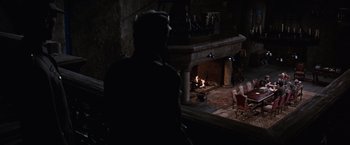 Movie still from “Where Eagles Dare” (1968), directed by Brian G. Hutton – A man sitting in front of a fire place; Wide shot, High angle