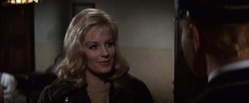Movie still from “Where Eagles Dare” (1968), directed by Brian G. Hutton – A woman with blonde hair wearing a brown jacket; Close Up shot, Over the shoulder angle