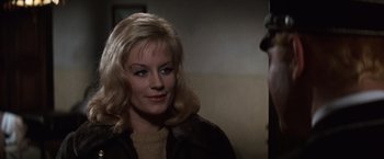 Movie still from “Where Eagles Dare” (1968), directed by Brian G. Hutton – A woman with blonde hair wearing a brown jacket; Close Up shot, Over the shoulder angle