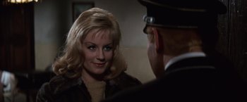 Movie still from “Where Eagles Dare” (1968), directed by Brian G. Hutton – A woman is looking at a man in a uniform; Close Up shot, Over the shoulder angle