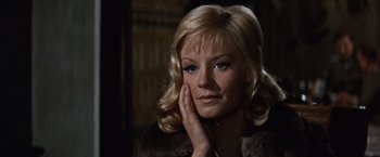 Movie still from “Where Eagles Dare” (1968), directed by Brian G. Hutton – A woman with blonde hair wearing a fur coat; Close Up shot, Low angle