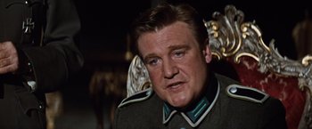 Movie still from “Where Eagles Dare” (1968), directed by Brian G. Hutton – A person wearing a military uniform; Close Up shot, Low angle