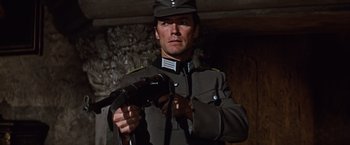 Movie still from “Where Eagles Dare” (1968), directed by Brian G. Hutton – A man in a military uniform holding a gun; Close Up shot, Low angle