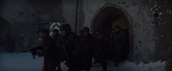 Movie still from “Where Eagles Dare” (1968), directed by Brian G. Hutton – A group of men in military uniforms walking down a street; Wide shot, High angle