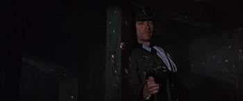 Movie still from “Where Eagles Dare” (1968), directed by Brian G. Hutton – A man in a uniform holding a camera; Medium shot, Low angle