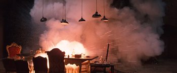 Movie still from “Where Eagles Dare” (1968), directed by Brian G. Hutton – A table and chairs in front of an open fire place; Wide shot, High angle