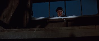 Movie still from “Where Eagles Dare” (1968), directed by Brian G. Hutton – A man wearing a hat looking out of a window; Medium shot, Low angle