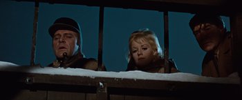Movie still from “Where Eagles Dare” (1968), directed by Brian G. Hutton – A woman looking out of a window at night; Close Up shot, Low angle