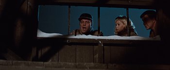 Movie still from “Where Eagles Dare” (1968), directed by Brian G. Hutton – A man and a woman looking out of a window; Medium shot, Low angle