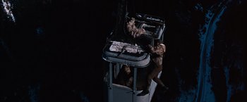 Movie still from “Where Eagles Dare” (1968), directed by Brian G. Hutton – Two men are climbing up the side of a cable car; Wide shot, High angle