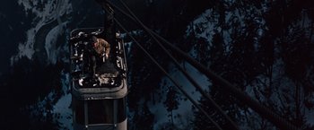 Movie still from “Where Eagles Dare” (1968), directed by Brian G. Hutton – A man standing on top of a cable car; Wide shot, High angle