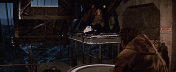 Movie still from “Where Eagles Dare” (1968), directed by Brian G. Hutton – A woman sitting on top of a metal platform; Wide shot, High angle