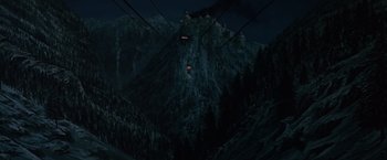 Movie still from “Where Eagles Dare” (1968), directed by Brian G. Hutton – A view of a mountain from a gondola at night time; Extreme Wide shot, Low angle