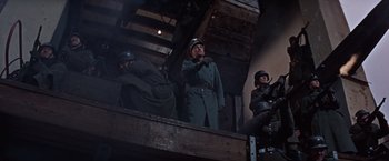Movie still from “Where Eagles Dare” (1968), directed by Brian G. Hutton – A group of men in uniforms standing next to each other; Medium shot, Low angle