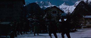 Movie still from “Where Eagles Dare” (1968), directed by Brian G. Hutton – A group of people walking in the snow with umbrellas; Extreme Wide shot, Low angle
