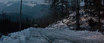 Movie still from “Where Eagles Dare” (1968), directed by Brian G. Hutton – A car driving down a snow covered road near a forest; Extreme Wide shot, High angle
