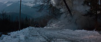 Movie still from “Where Eagles Dare” (1968), directed by Brian G. Hutton – A truck driving down a snowy road near a forest; Extreme Wide shot, High angle
