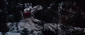 Movie still from “Where Eagles Dare” (1968), directed by Brian G. Hutton – A train traveling down tracks next to a forest; Extreme Wide shot, High angle