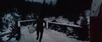Movie still from “Where Eagles Dare” (1968), directed by Brian G. Hutton – A man running across a snow covered bridge; Wide shot, High angle