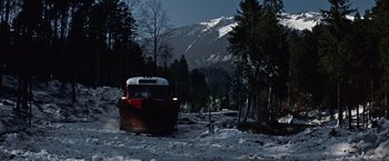 Movie still from “Where Eagles Dare” (1968), directed by Brian G. Hutton – A red and white boat on a snowy road; Extreme Wide shot, High angle