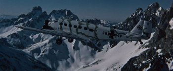 Movie still from “Where Eagles Dare” (1968), directed by Brian G. Hutton – An airplane is flying over a snowy mountain; Extreme Wide shot, Low angle
