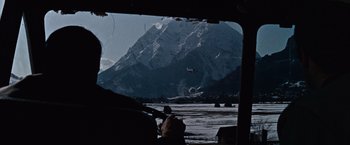 Movie still from “Where Eagles Dare” (1968), directed by Brian G. Hutton – An airplane is flying over a snowy mountainous area; Extreme Wide shot, Low angle