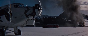 Movie still from “Where Eagles Dare” (1968), directed by Brian G. Hutton – An airplane is flying in the sky near a bus; Extreme Wide shot, Low angle