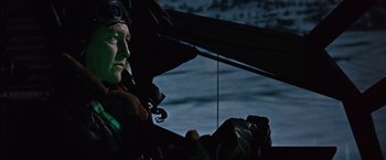 Movie still from “Where Eagles Dare” (1968), directed by Brian G. Hutton – A man wearing a pilot's suit and goggles is sitting in a boat; Close Up shot, Low angle