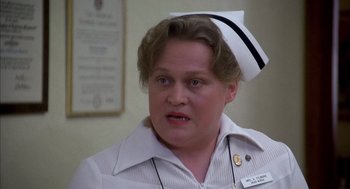 Movie still from “Where the Buffalo Roam” (1980), directed by Art Linson – A woman wearing a nurse's uniform and a white hat; Close Up shot, High angle