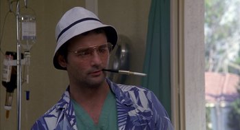 Movie still from “Where the Buffalo Roam” (1980), directed by Art Linson – A man with a hat and a pipe in his mouth; Close Up shot, Low angle